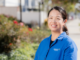 Caixia Jiang poses in front of Torrance Adult School. Her story demonstrates the impact of adult schools.