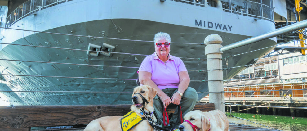 Photo of a veteran and her two dogs who were part of a service dog training organization